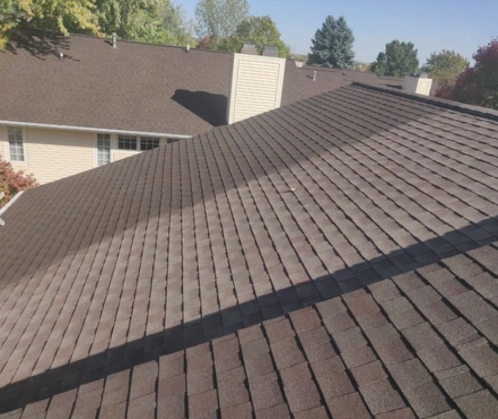 Aerial close-up view of brown asphalt shingle roof texture